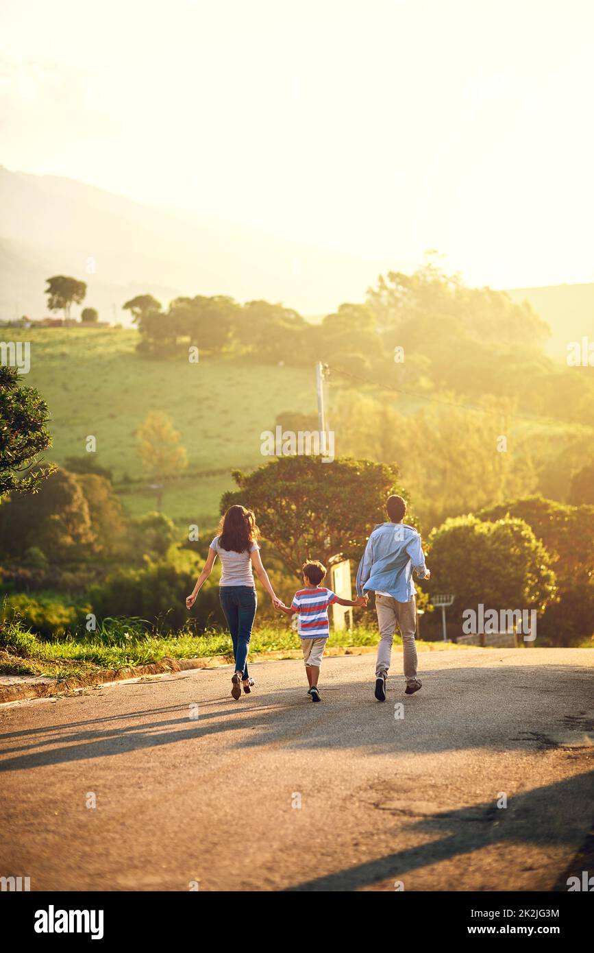 Passeggiando per una giornata piacevole. Foto retrostensiva di una famiglia che cammina in campagna. Foto Stock