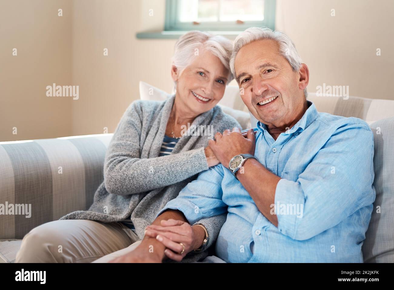 La vita ruota intorno alle persone che contano per te. Scatto di una coppia anziana che si rilassa insieme sul divano di casa. Foto Stock