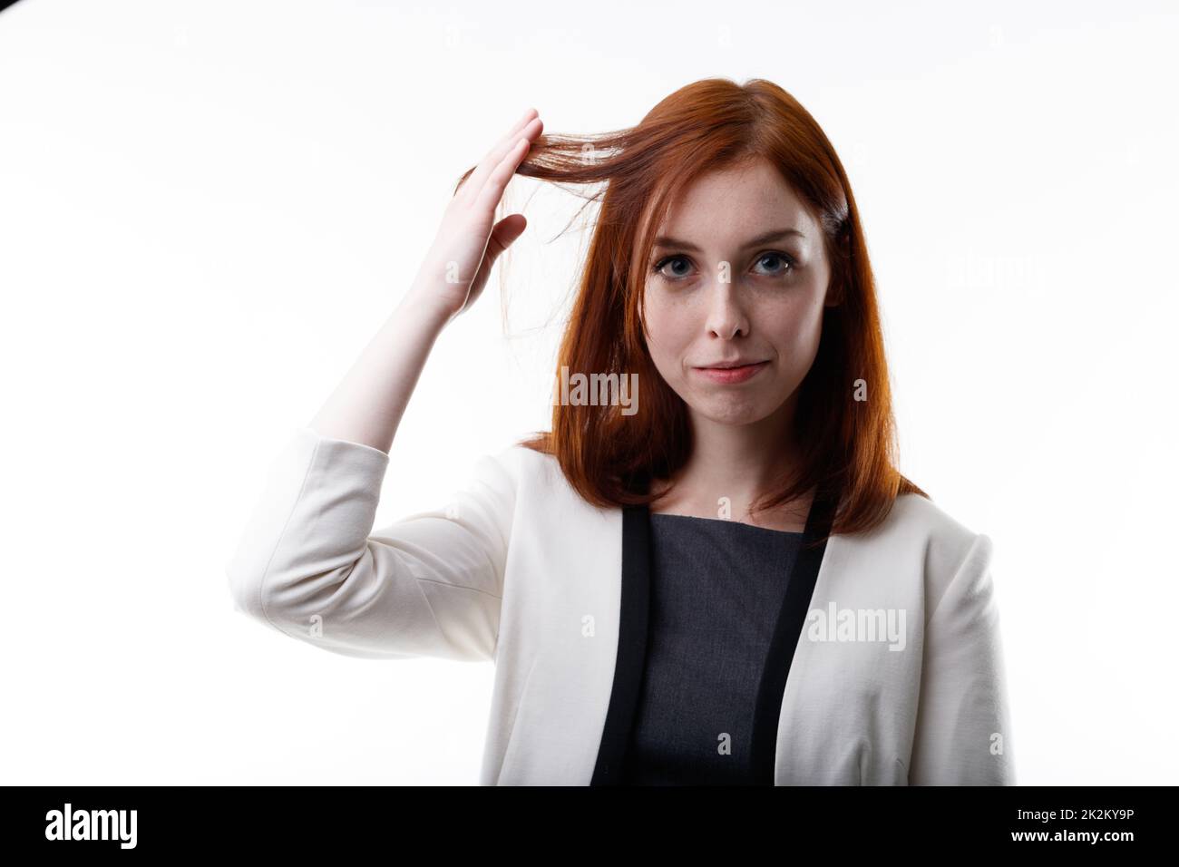 Donna seria giovane arrhead che tiene su una ciocca di capelli Foto Stock