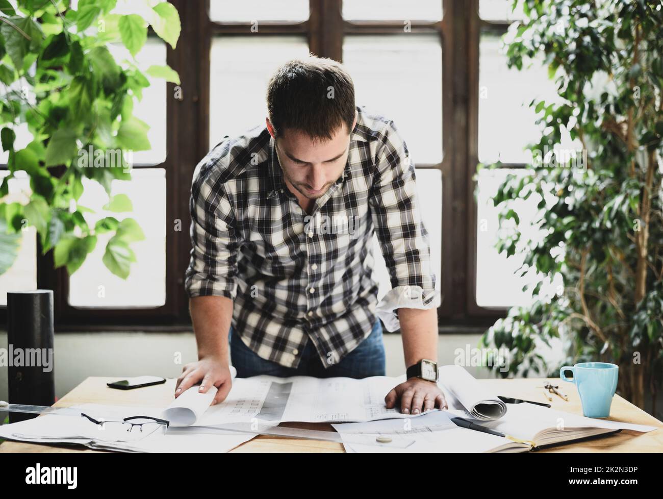 Uomo che lavora a un progetto architettonico Foto Stock