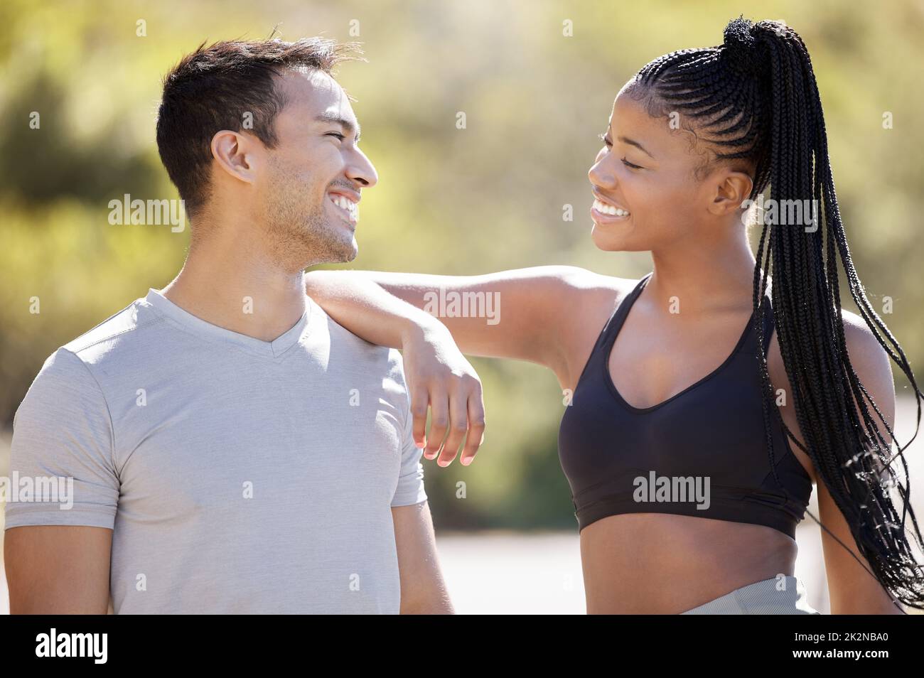 Uomo asiatico, donna nera e lavoro di squadra di fitness in parco naturale e giardino ambiente in allenamento, allenamento e esercizio. Felice, sorriso e motivazione Foto Stock