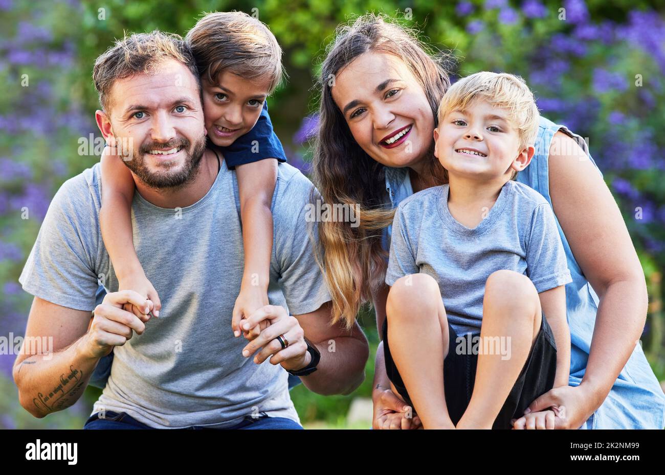 Pensavi che non cercavo, stavo imparando ad amare. Ritratto di una bella famiglia con i loro figli sulle spalle in un parco. Foto Stock