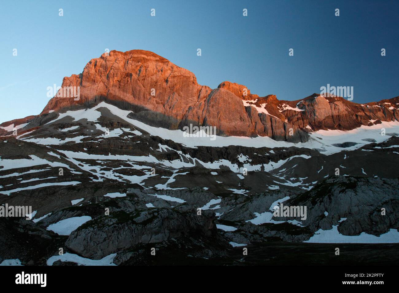 Montagna al mattino presto alba con alpenglow. Montagne alpine in Svizzera Foto Stock