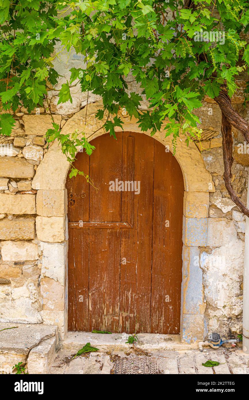 Porta vecchia e rovinosa in un vecchio villaggio greco durante il giorno Foto Stock