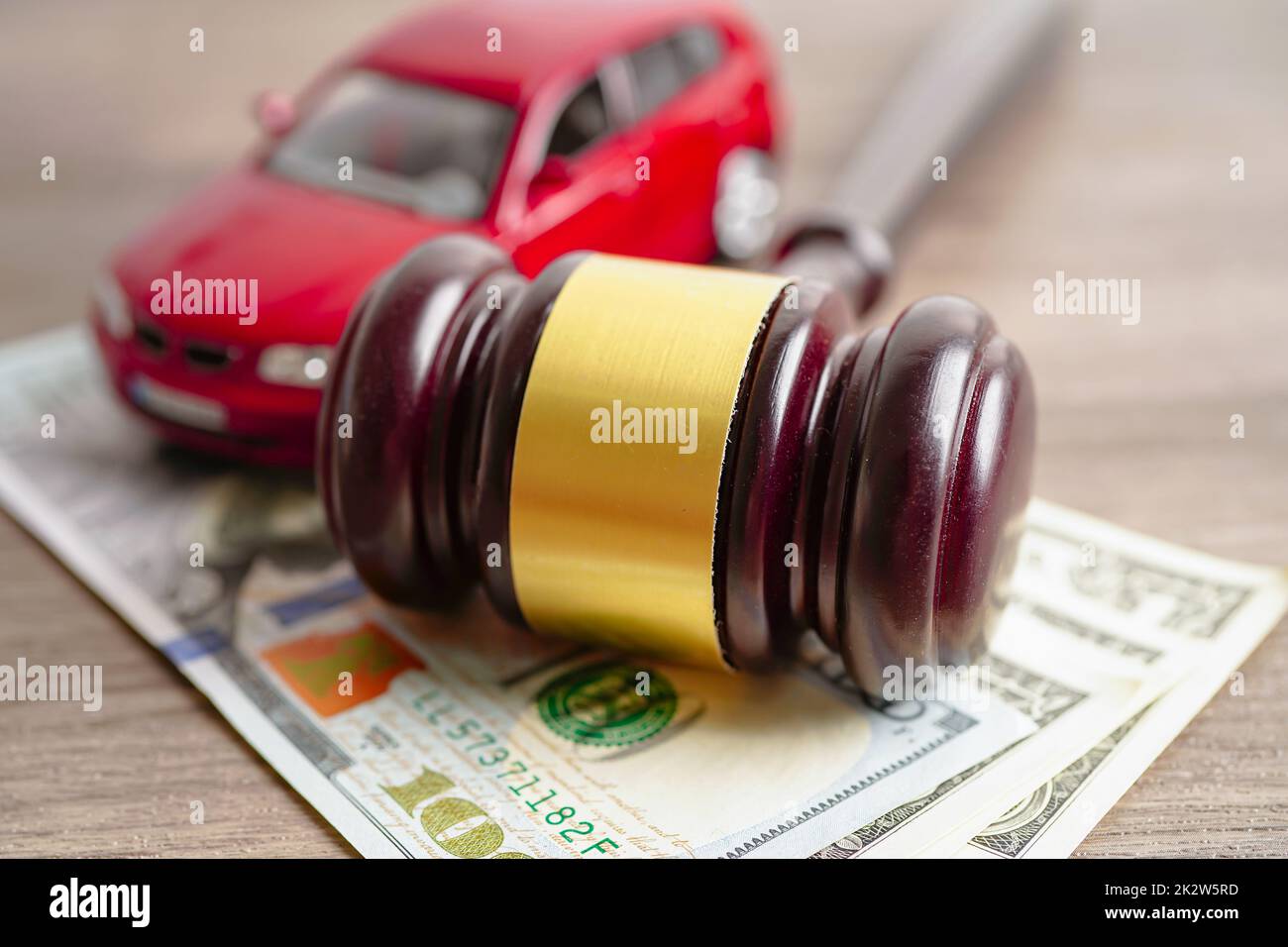 Gavel per giudice avvocato con auto su banconote in dollari USA, prestito auto, finanza, risparmio di denaro, legge, concetti di tempo di assicurazione e leasing. Foto Stock