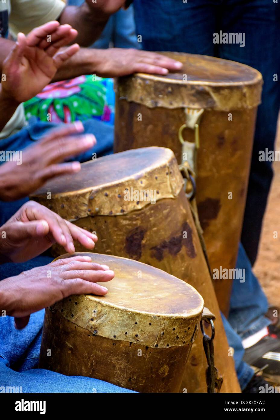 Gruppo di percussionisti che suonano un rudimentale atabaque Foto Stock