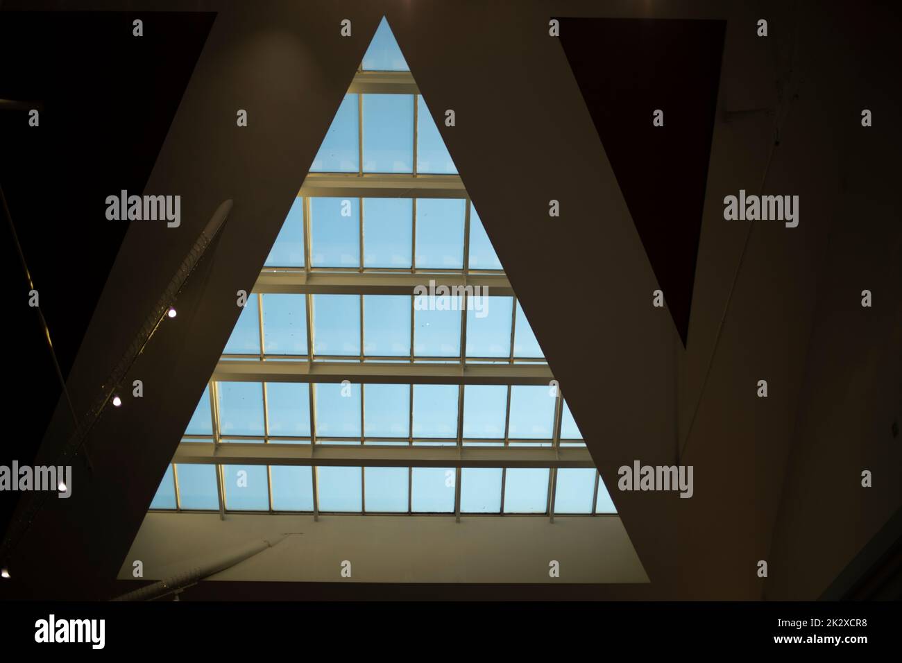 Finestra triangolare nell'edificio. Dettagli dell'architettura. Vetro nel tetto. Foto Stock