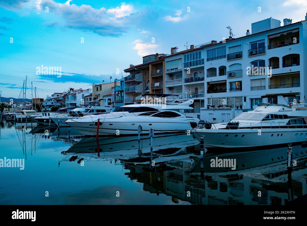 Le barche sono viste nel canale principale dell'acqua di Empuriabrava, Spagna il 25 agosto 2022 al crepuscolo in . Paesaggio della città catalana nella regione della Costa Brava kn Foto Stock
