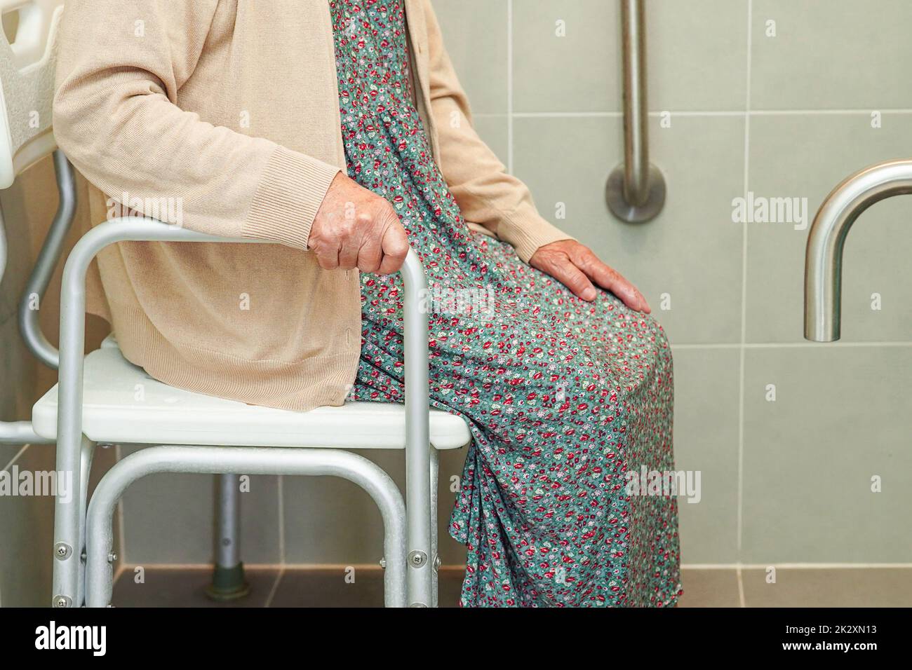 Anziana asiatica paziente donna uso servizi igienici sostegno in bagno, corrimano di sicurezza barra di presa, sicurezza in ospedale di cura. Foto Stock