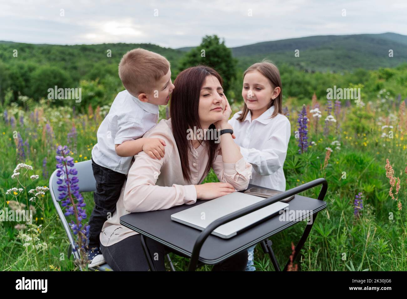 Bambini irritanti freelancer alla scrivania in lupini fiori Foto Stock