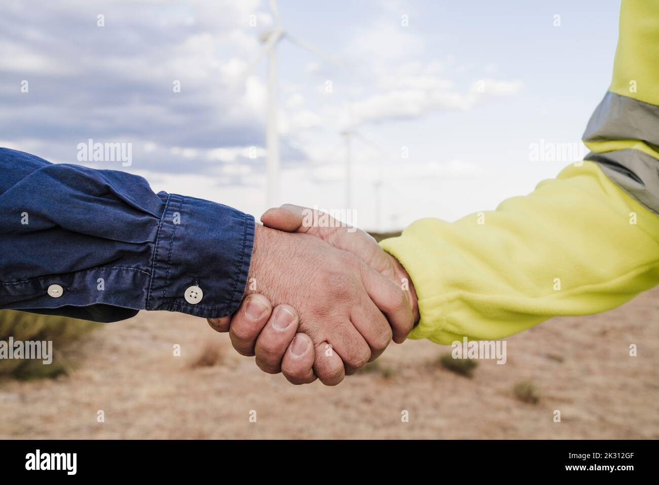 Ingegnere e tecnico che fa la stretta di mano alla fattoria eolica Foto Stock