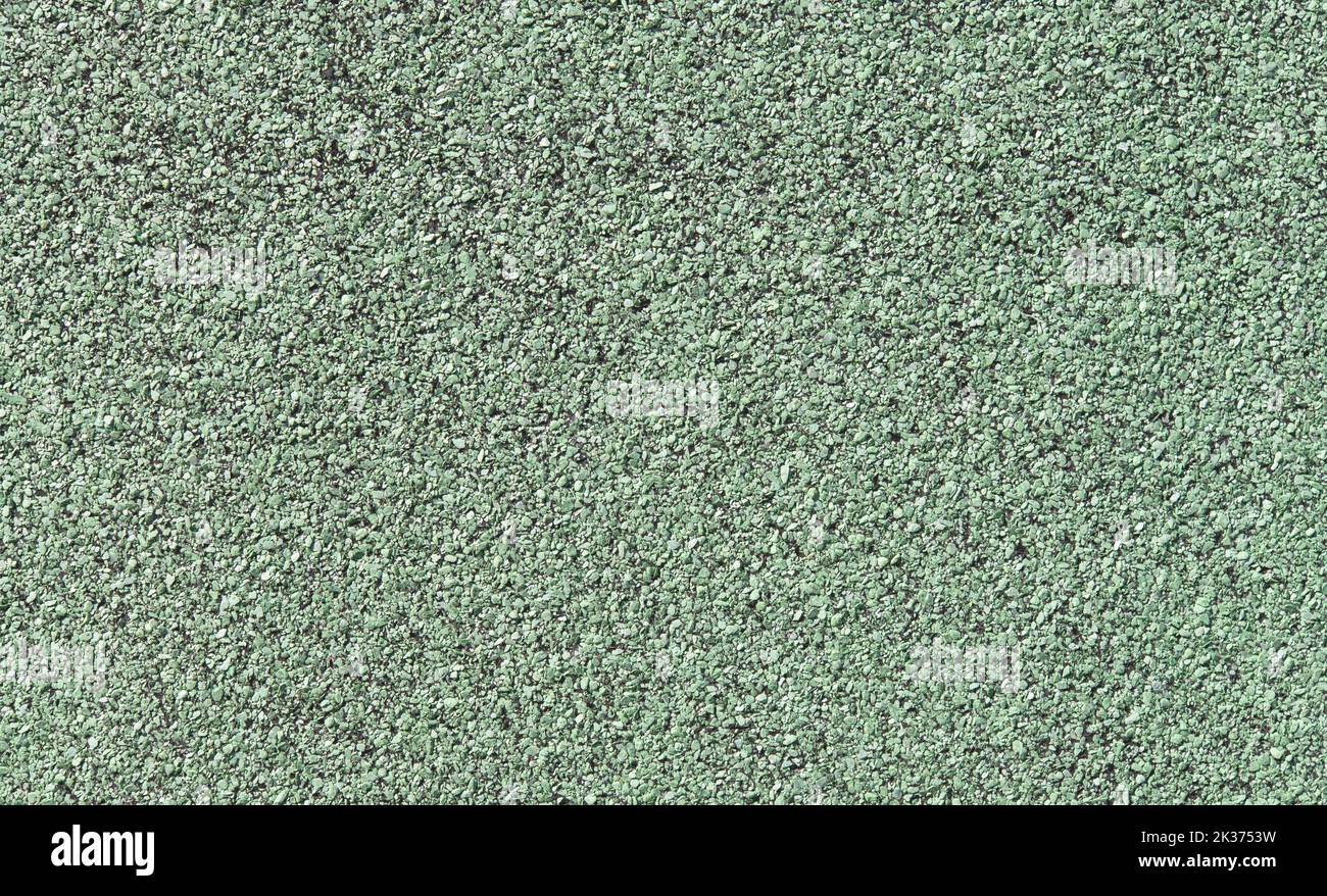 Pavimento granulare in gomma morbida primo piano, materiale verde chiaro sfondo texture Foto Stock