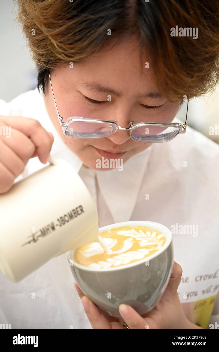 (220925) -- XI'AN, 25 settembre 2022 (Xinhua) -- Chen Jiayue, un barista non udente, fa una tazza di caffè presso il suo caffè a Xi'an, capitale della provincia Shaanxi del nord-ovest della Cina, 24 settembre 2022. La Giornata Internazionale dei sordi cade la quarta domenica di settembre. Dal 2019, la Shaanxi Urban Economy School offre formazione gratuita ai baristi per i non udenti. I tirocinanti possono imparare le abilità di preparazione del caffè così come la conoscenza di funzionamento del caffè durante il programma di formazione, che potrebbe aiutarli nel preparare il senso o per iniziare il loro commercio del caffè o ottenere impiegato in questo settore Foto Stock