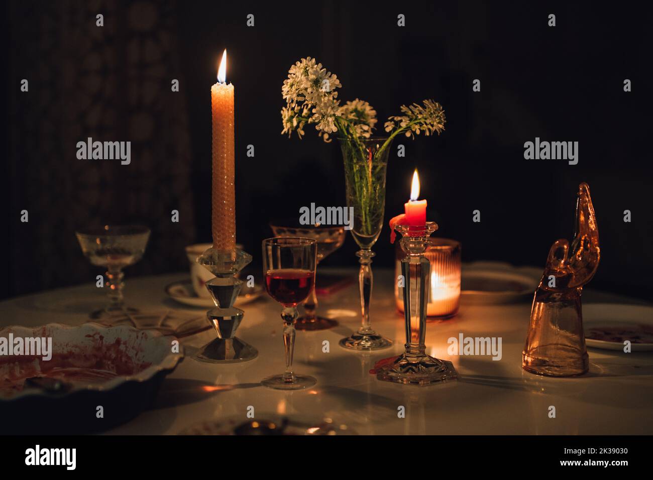 tavolo da sera con candele, cocktail, vino, fiori Foto Stock