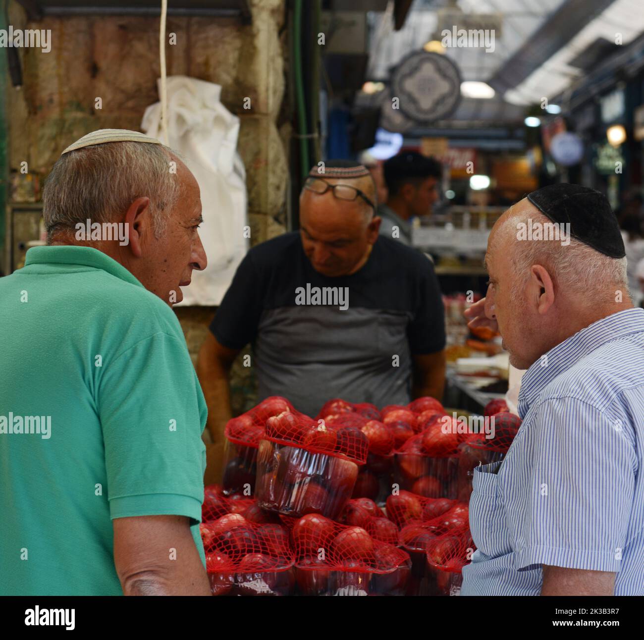 Uomini socializzanti al mercato di Machane Yehuda a Gerusalemme, Israele. Foto Stock