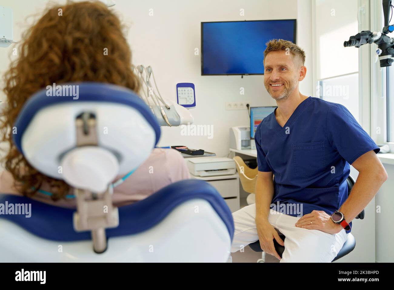 Dentista che ha consulto con il paziente nella sua ambulanza. Foto Stock
