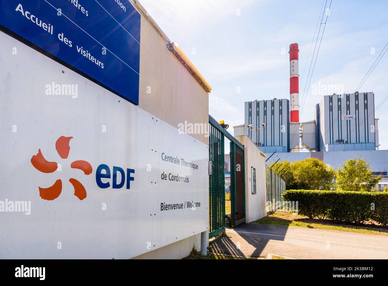 Cartello di benvenuto e edificio principale della centrale elettrica a carbone del FES di Cordemais, vicino a Nantes, Francia, in una giornata estiva di sole. Foto Stock