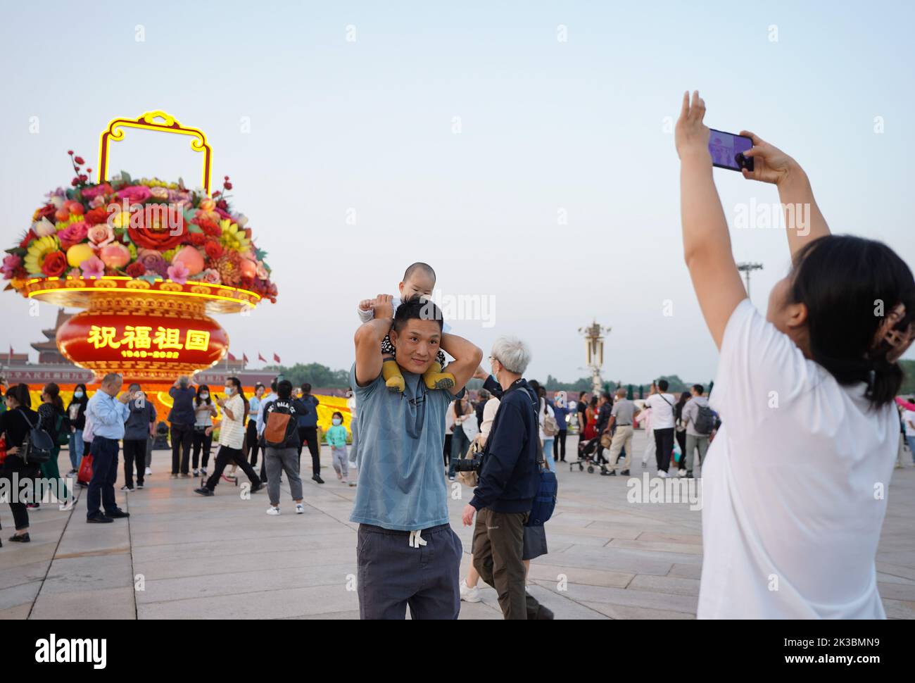 Pechino, Cina. 25th Set, 2022. I turisti posano per le foto di fronte a un 'cesto di fiori' in Piazza Tian'anmen a Pechino, capitale della Cina, 25 settembre 2022. L'esposizione alta 18 metri a forma di cesto di fiori è collocata in Piazza Tian'anmen come decorazione per la prossima festa della Giornata Nazionale. Credit: Chen Zhonghao/Xinhua/Alamy Live News Foto Stock