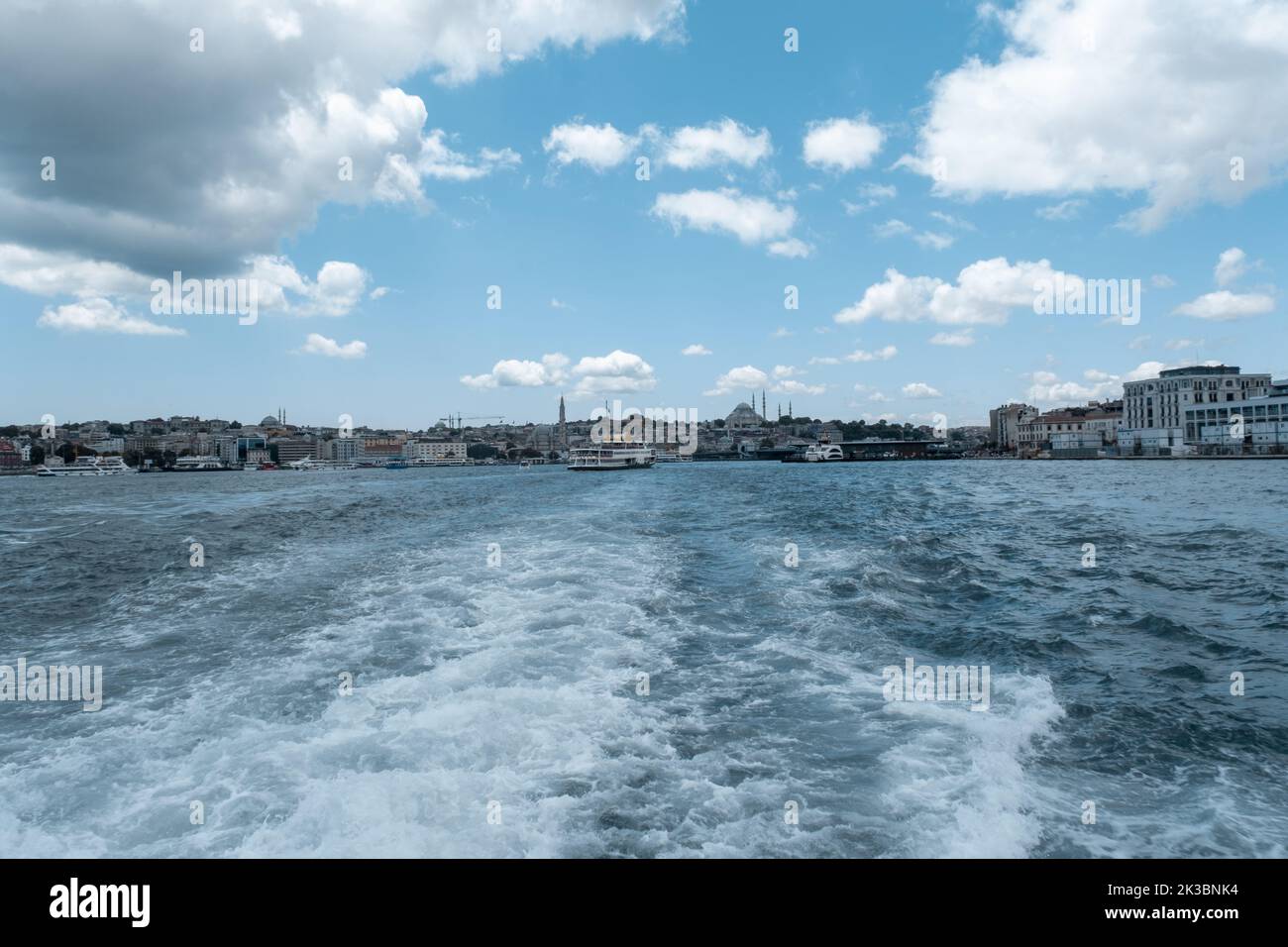 Vista di Istanbul con un traghetto in Bosforo, paesaggio con mare ondulato e cielo nuvoloso, vista posteriore nave sul mare, concetto marino, viaggio con ferr Foto Stock