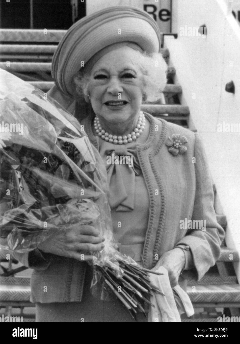 Englische Autorin Dame Mary Barbara Hamilton Cartland bei der ANkunft am Flughafen mit einem Blumenstrauß, Ende 1980er Jahre - Fotobuch Band 1 von 2012: PROmi- Porträts fotografiert von Hartwig 'Valdi' Valdmanis Foto Stock