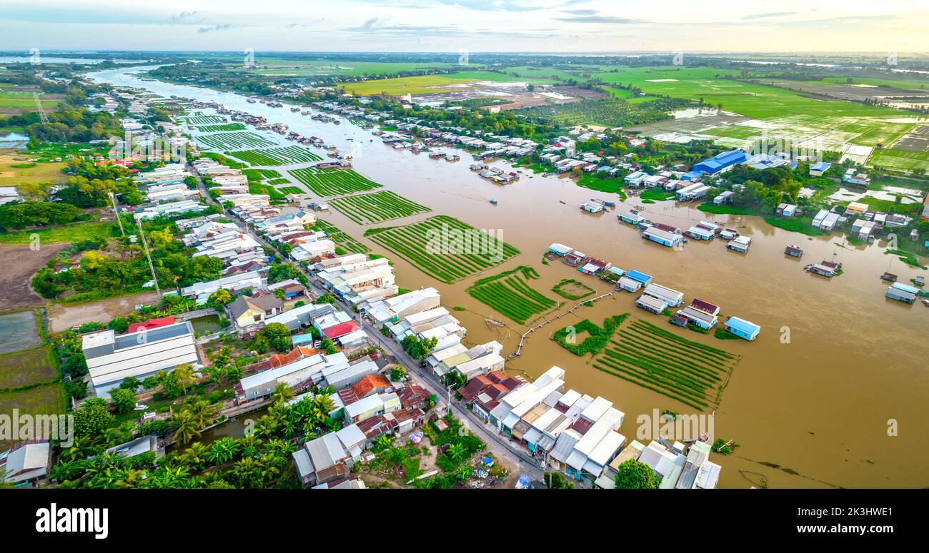 Villaggio galleggiante lungo il fiume Hau sopra la zona di confine del Vietnam, vista aerea. Il bacino del fiume contiene molti frutti di mare e alluvione per l'agricoltura Foto Stock