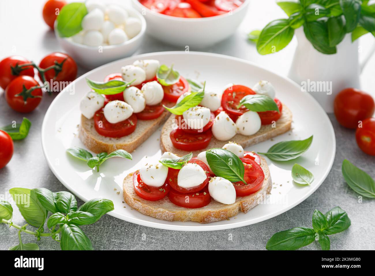 Toast caprese con mozzarella, pomodoro ciliegia e basilico Foto Stock