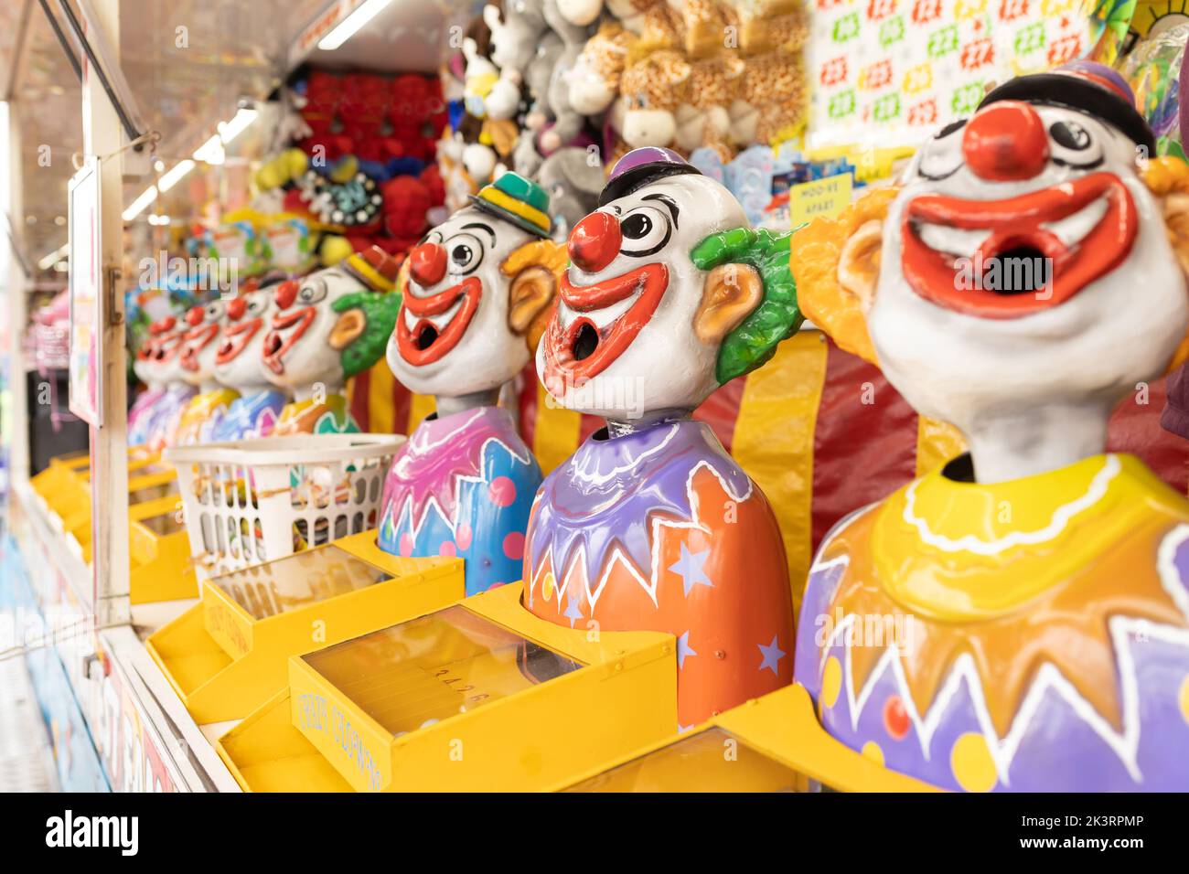 Ridendo clown gioco di attrazione in un carnevale equo Foto Stock