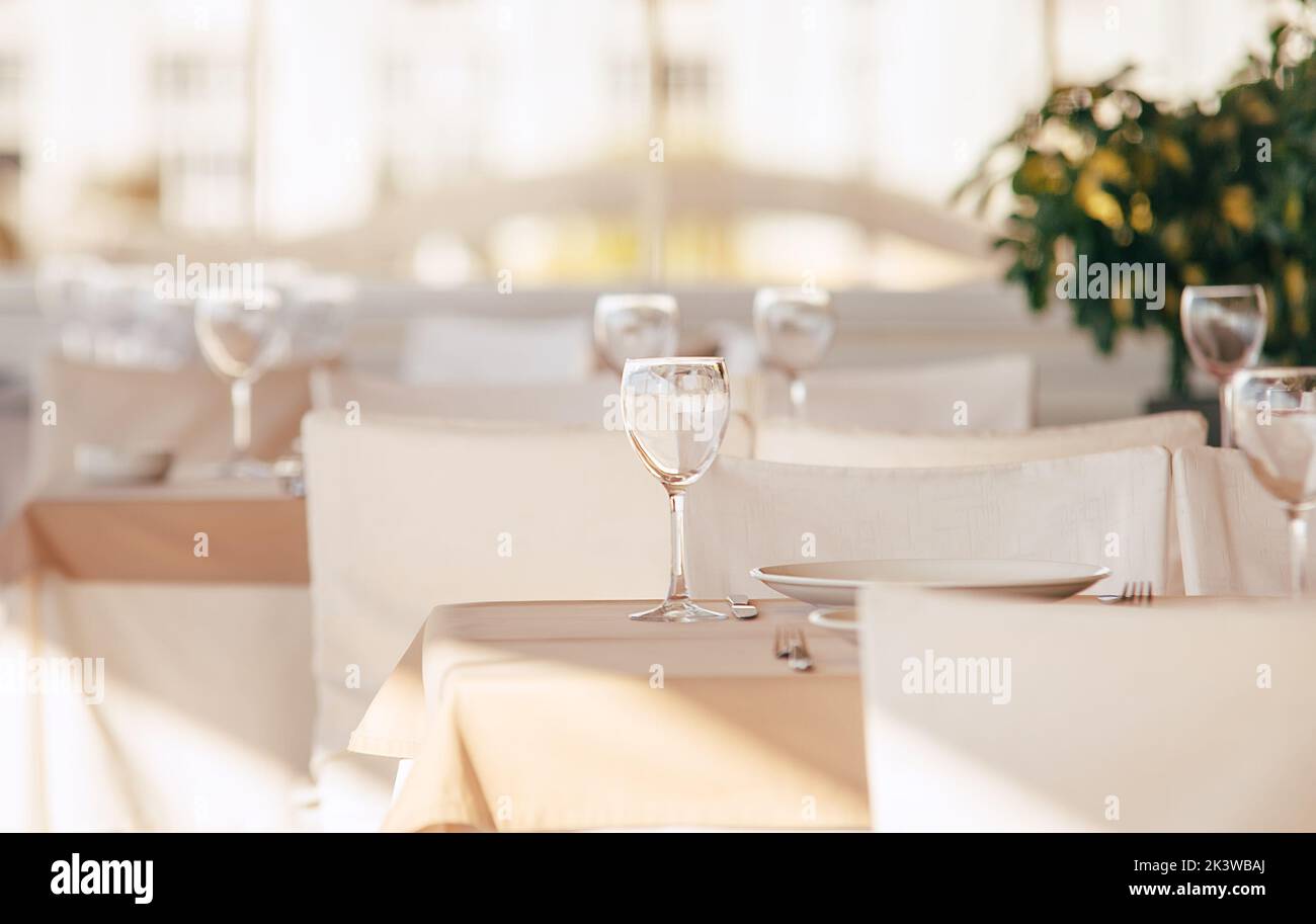 Bicchiere di vino vuoto in piedi sulla tovaglia. Ristorante di lusso con colori bianchi al coperto. Foto Stock