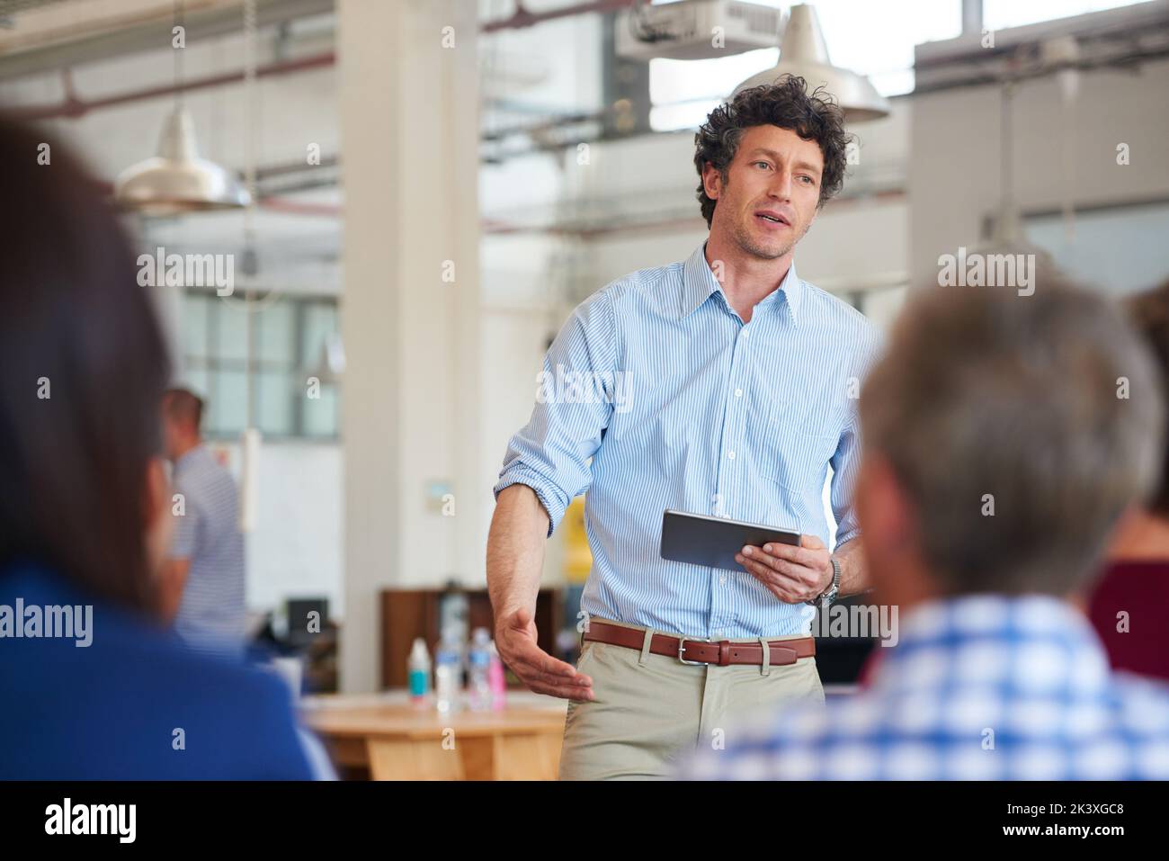 Diventa il cambiamento che desideri vedere. Designer che offre una presentazione ai suoi colleghi utilizzando un tablet digitale. Foto Stock