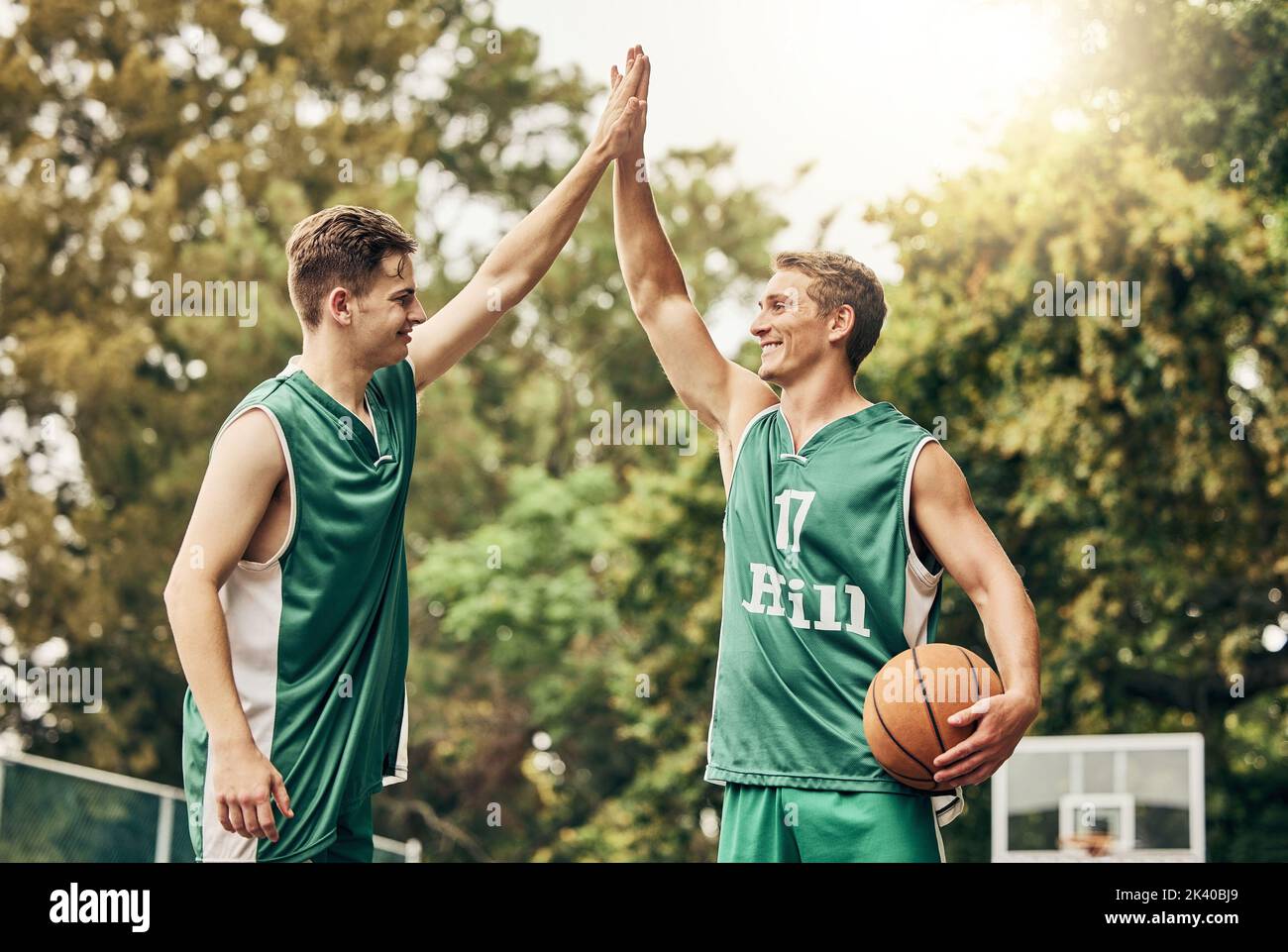 Sport, basket e high five in un campo da basket con mani maschili collegate a sostegno della missione di fitness. Squadra, energia e motivazione da Foto Stock