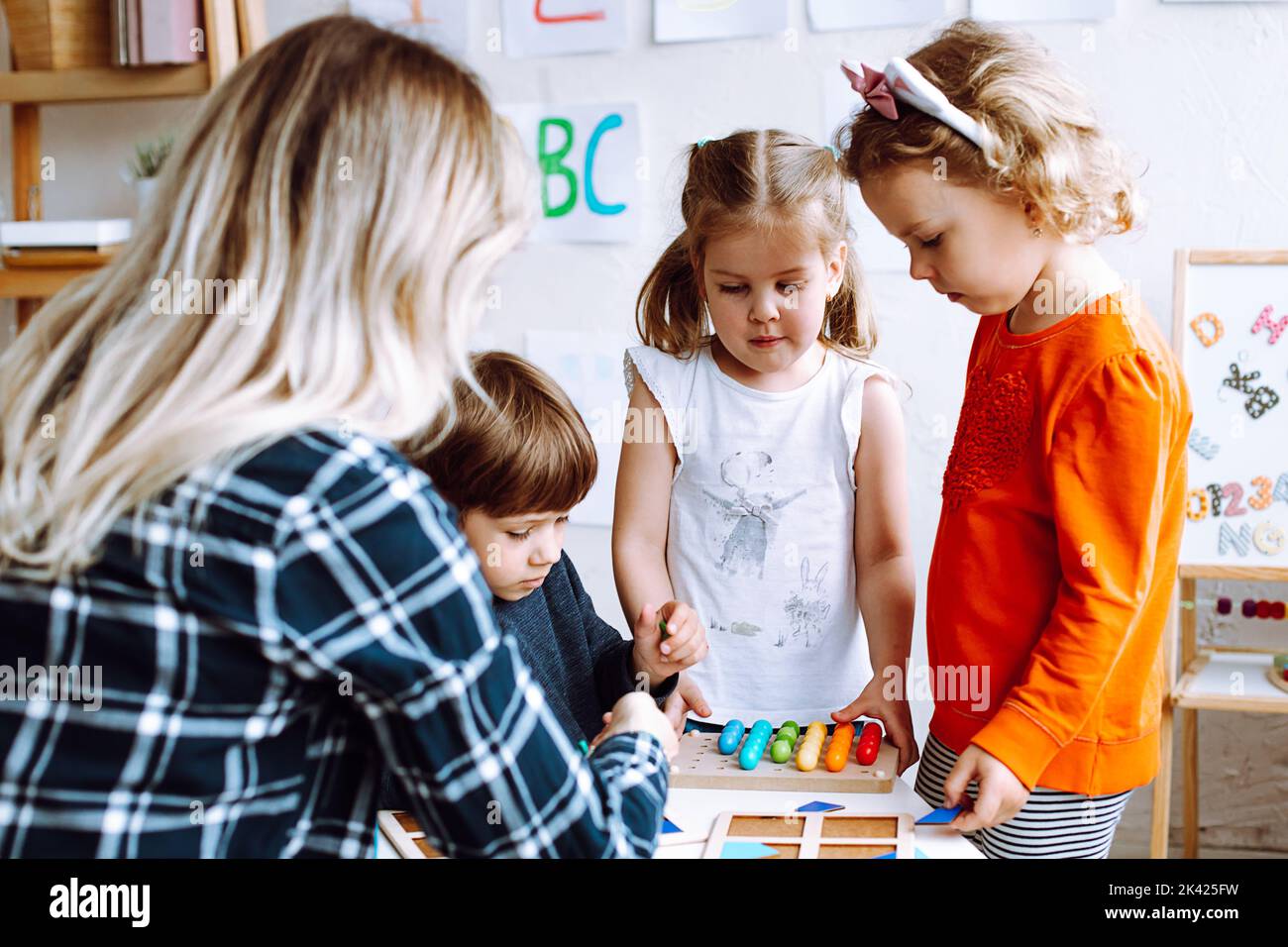 Classe di sviluppo per bambini per l'arte, la logica e lo studio. L'insegnante con i bambini intelligenti impara nel centro di assistenza bambini di sviluppo Foto Stock