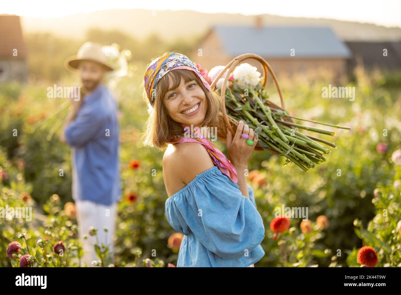 Donna con fiori in fattoria dahlia all'aperto Foto Stock