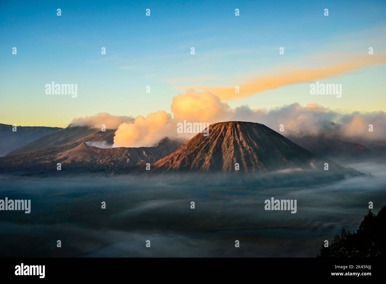 Monte bromo vulcano, un vulcano somma e parte della catena montuosa Tengger, il cono che si erge sopra la nebbia nel paesaggio. Foto Stock
