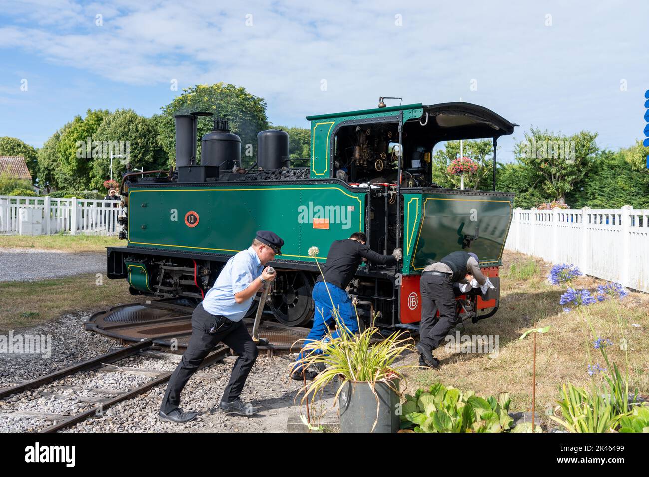 Lavoratori ferroviari che azionano manualmente una piattaforma girevole per girare una locomotiva a vapore. Foto Stock