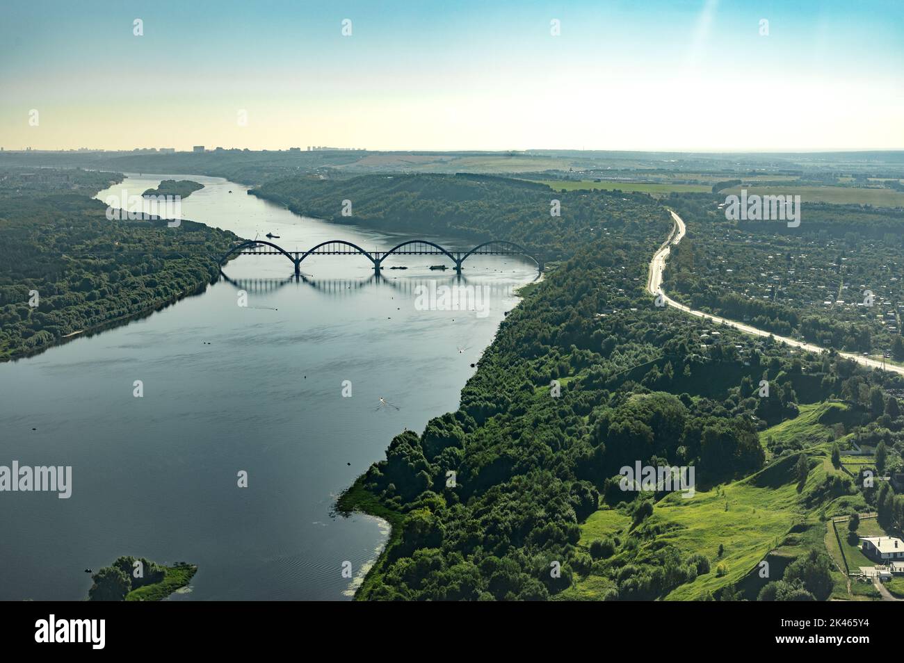 fotografie aeree da una finestra dell'aeroplano volo sul fiume con ponte al tramonto estivo Foto Stock