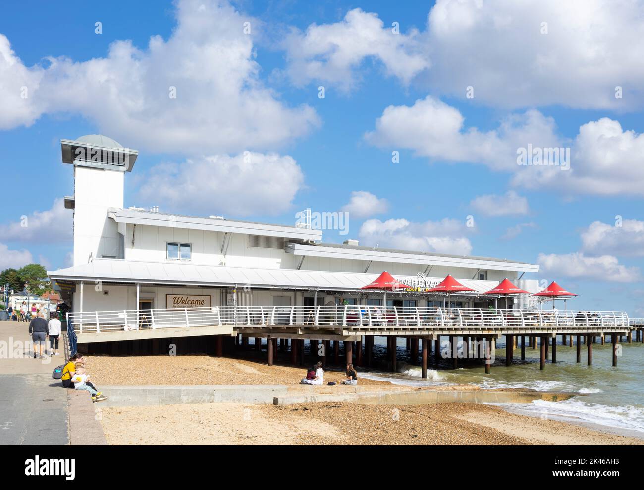 La gente sul lungomare di Felixstowe cammina verso il molo di Felixstowe e la spiaggia sabbiosa di Felixstowe Beach Felixstowe Suffolk Inghilterra UK GB Europa Foto Stock