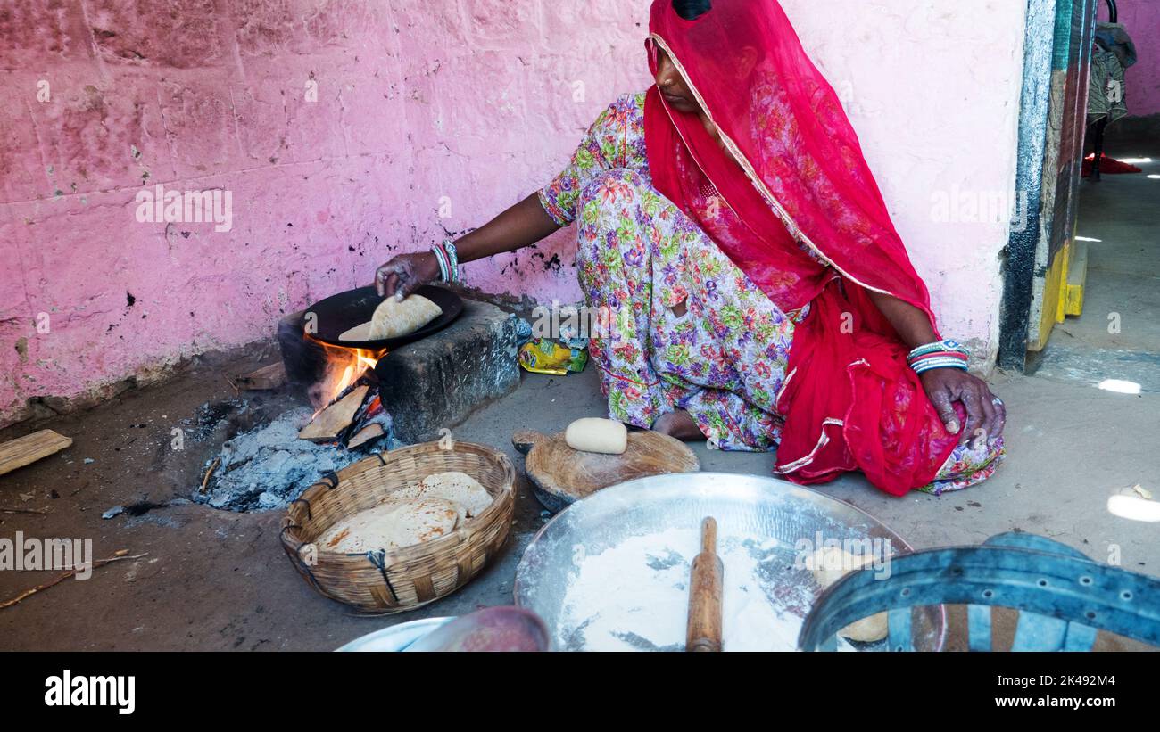 Bhinmal Rajasthan, India - 23 maggio 2017 : ragazza indiana villaggio rurale preparare roti o chapatti cibo su stufa di legno tradizionale. Foto Stock