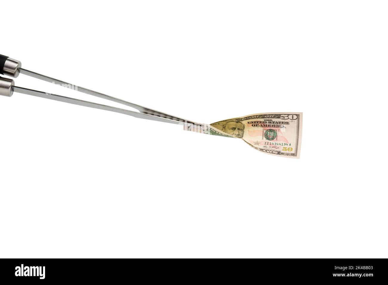 Un'attrezzatura per barbecue come simbolo di corruzione. Isolato su sfondo bianco. Primo piano. Foto Stock