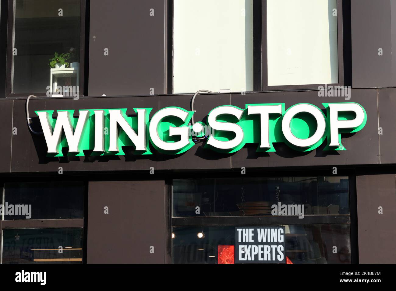 Un logo del ristorante fast food Wing Stop su un edificio Foto Stock