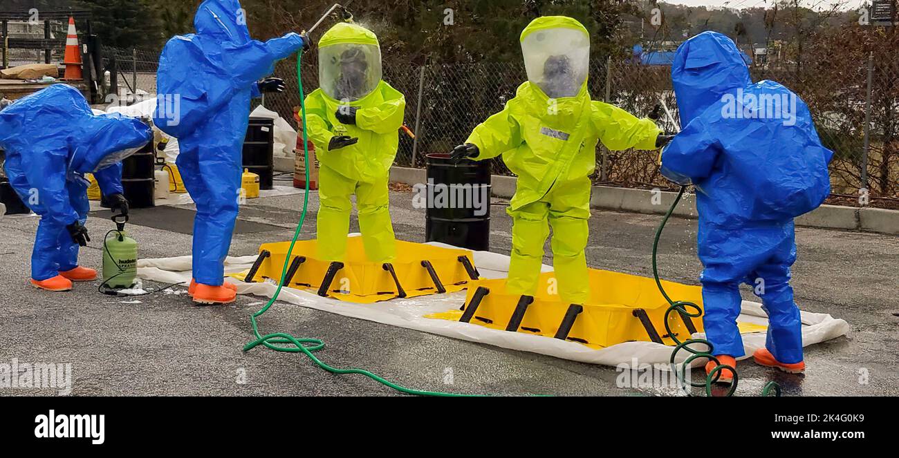 Una squadra di risposta di fentanyl dell'applicazione della legge - in HAZMAT si adatta lavando giù dopo che lavorasse con il farmaco Foto Stock