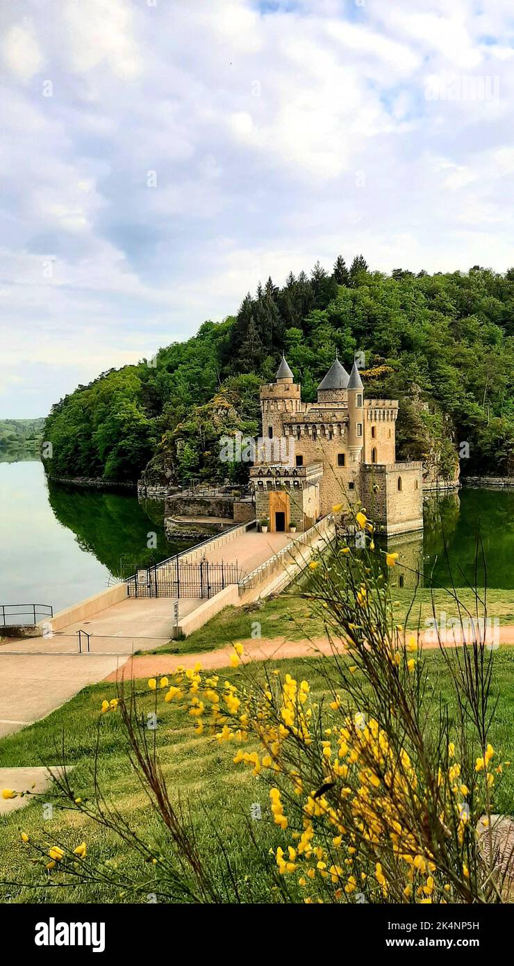 Un colpo verticale di Castello a Saint Priest la Roche circondato da alberi verdi e erba Foto Stock