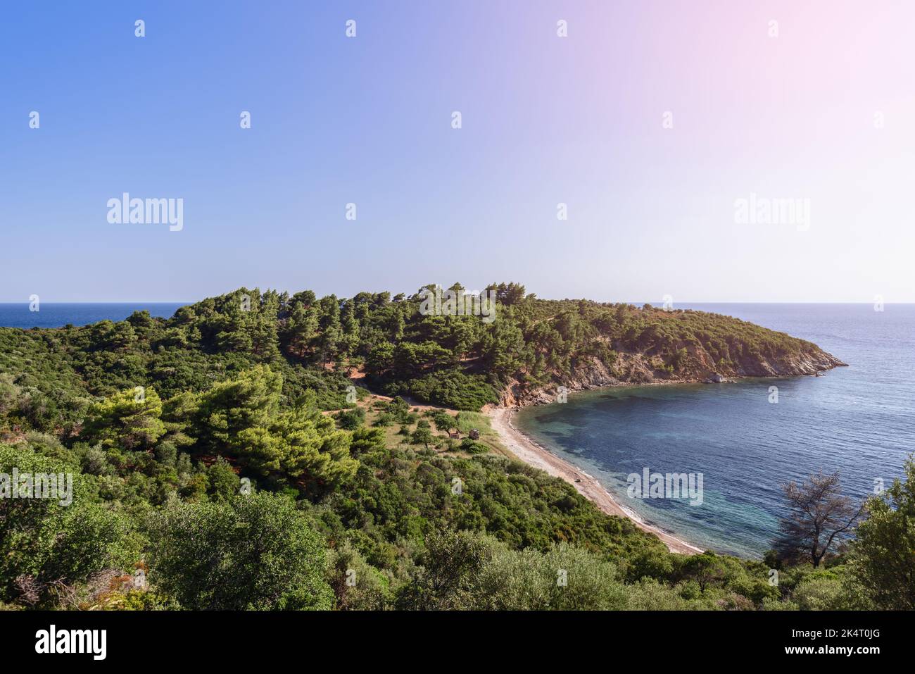 Vista panoramica del piccolo capo, che fa parte della penisola di Sithonia, coltivata con vegetazione fitta tra cui alberi, con stretta striscia di spiaggia di sabbia, Chalki Foto Stock