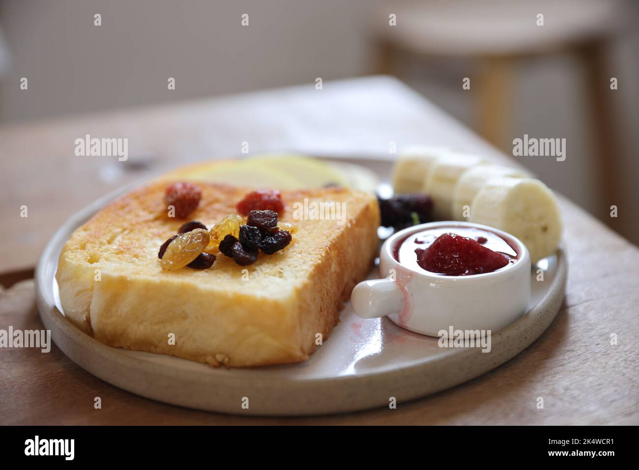 Toast colazione con bacche secche e marmellata su sfondo di legno Foto Stock