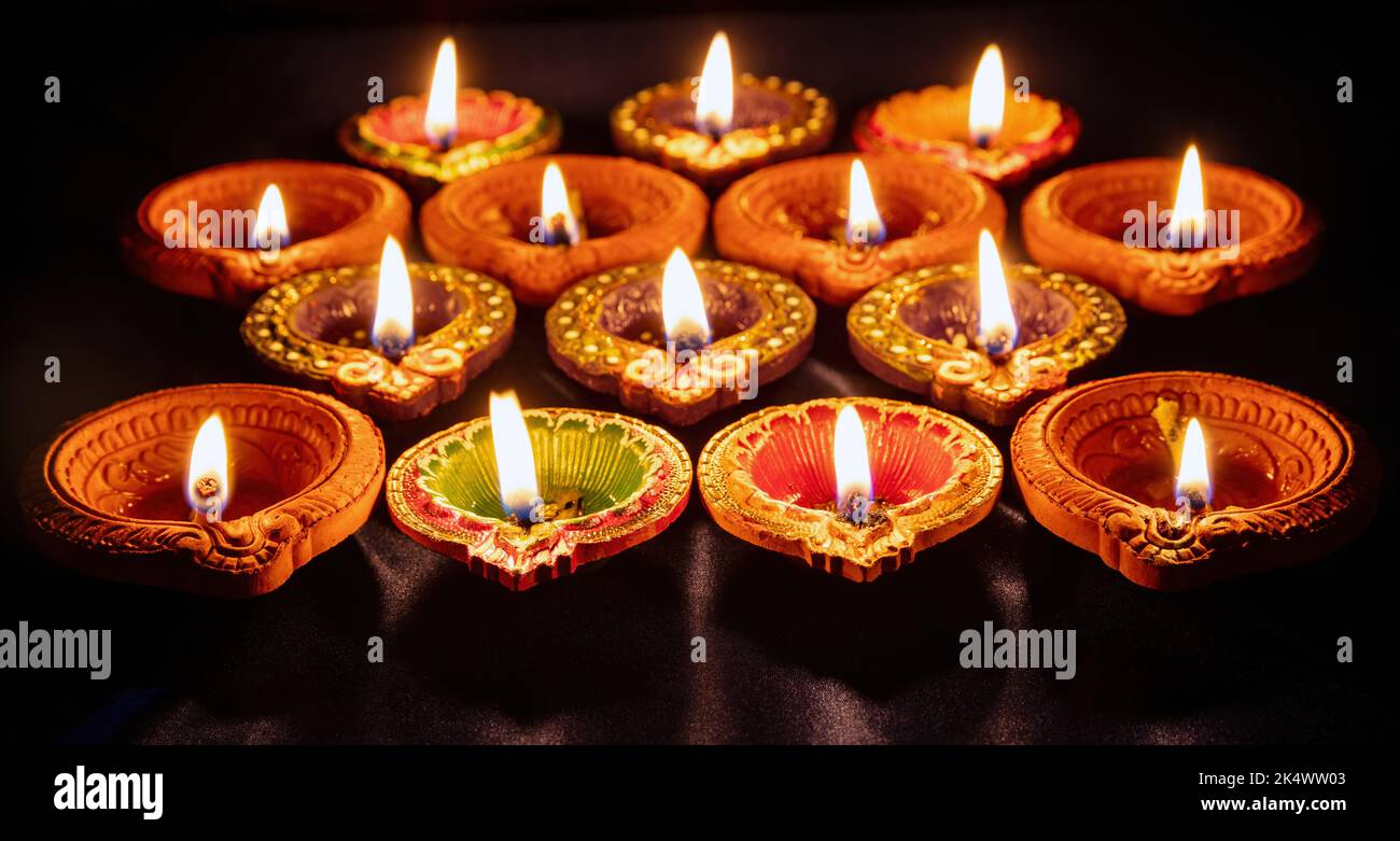 Diwali. Deepavali Hindu festival di luci. Candela diya di argilla. Spia dell'olio accesa su sfondo scuro Foto Stock