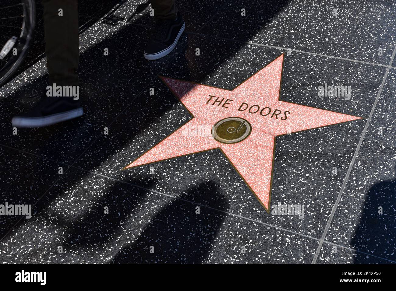 La famosa stella del 'The Doors' incastonata nel pavimento del terrazzo dell'Hollywood Boulevard Walk of Fame circondato da ombre di turisti. Foto Stock