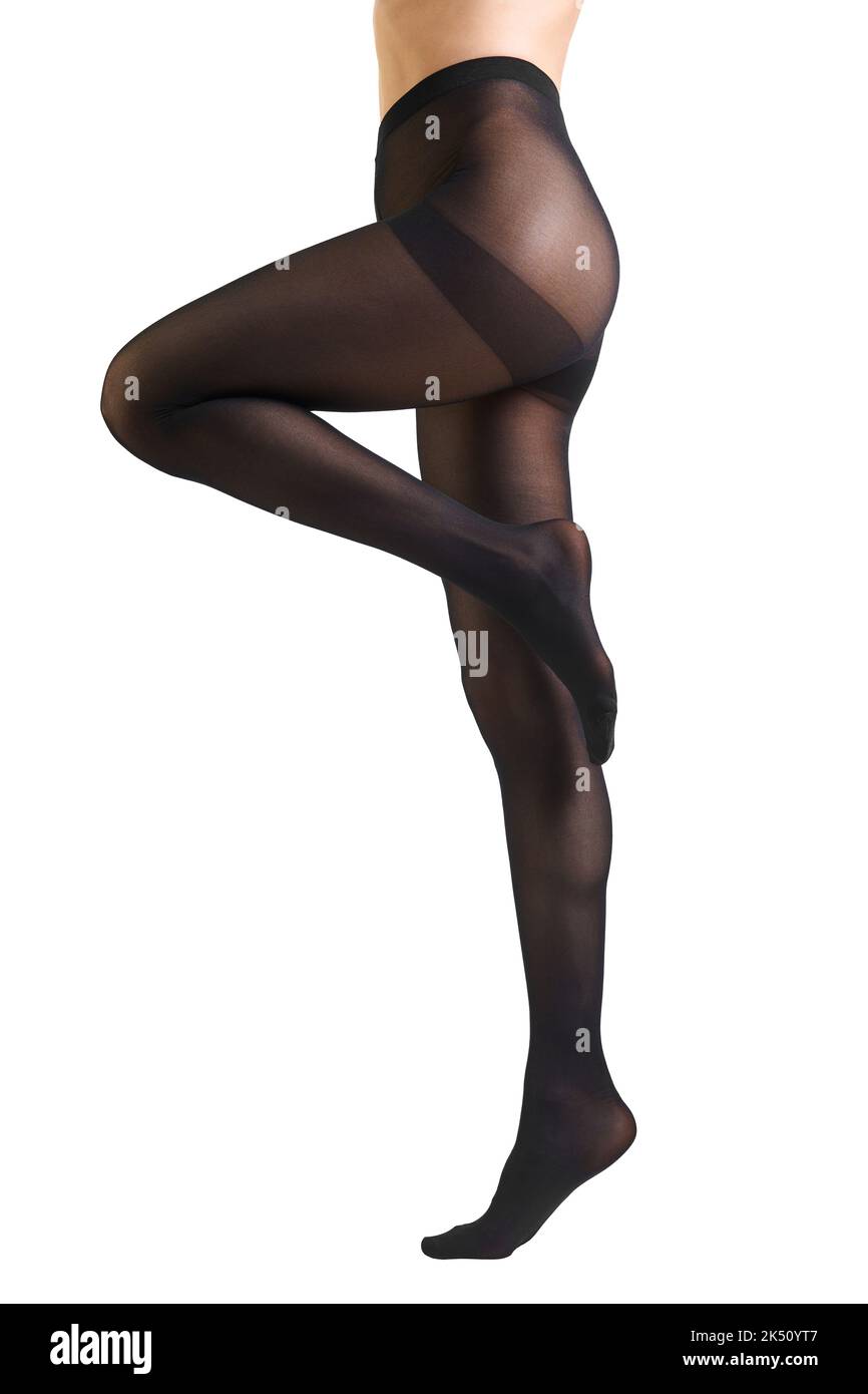 Gambe femminili sottili in collant nero denso con effetto stringente Foto Stock