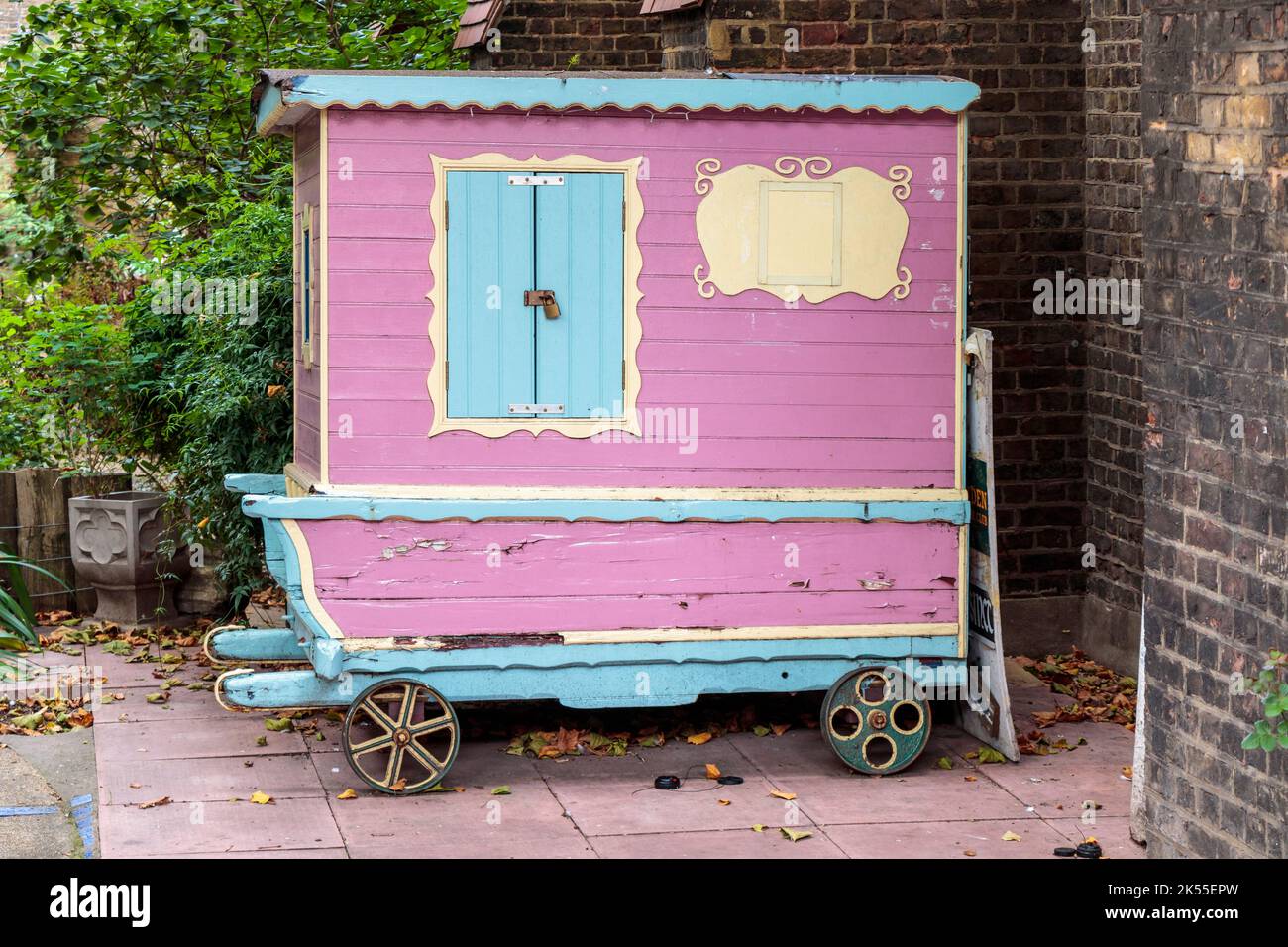 Un capannone a ruote dipinto con colori, o caravan, nei terreni della chiesa di San Michele a Camden Town, Londra, Regno Unito Foto Stock