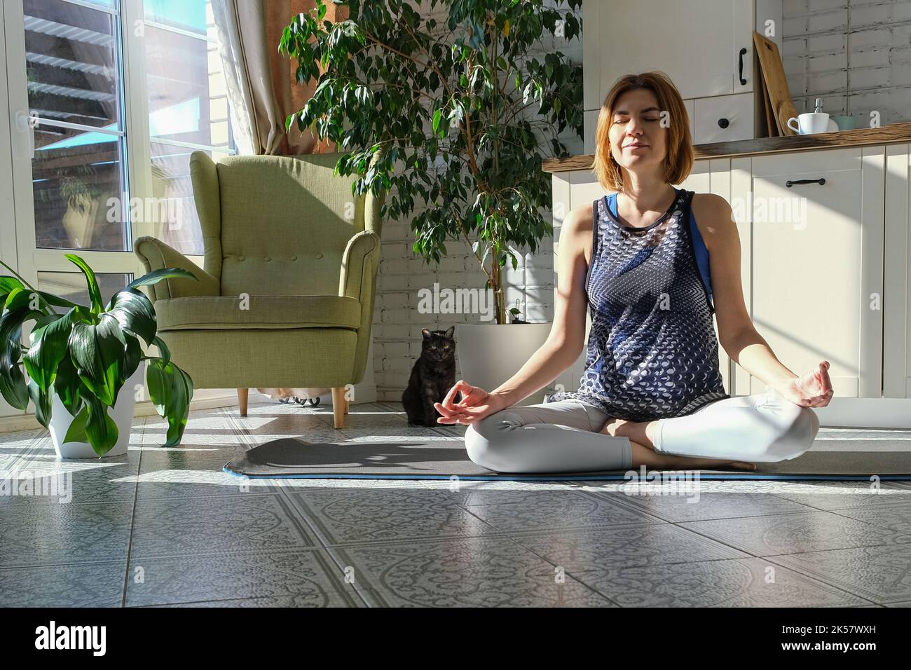 Donna di mezza età che pratica la meditazione a casa, calma anziana signora di mezza età in lotus posa fare yoga per l'equilibrio mentale respirare aria rilassante Foto Stock