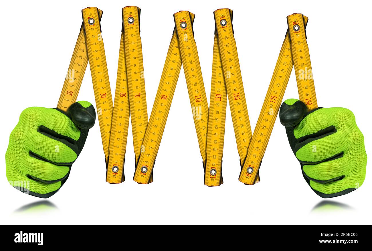 Operatore manuale con guanti da lavoro protettivi, con un vecchio righello pieghevole giallo e arancione (metro), isolato su sfondo bianco con riflessi. Foto Stock