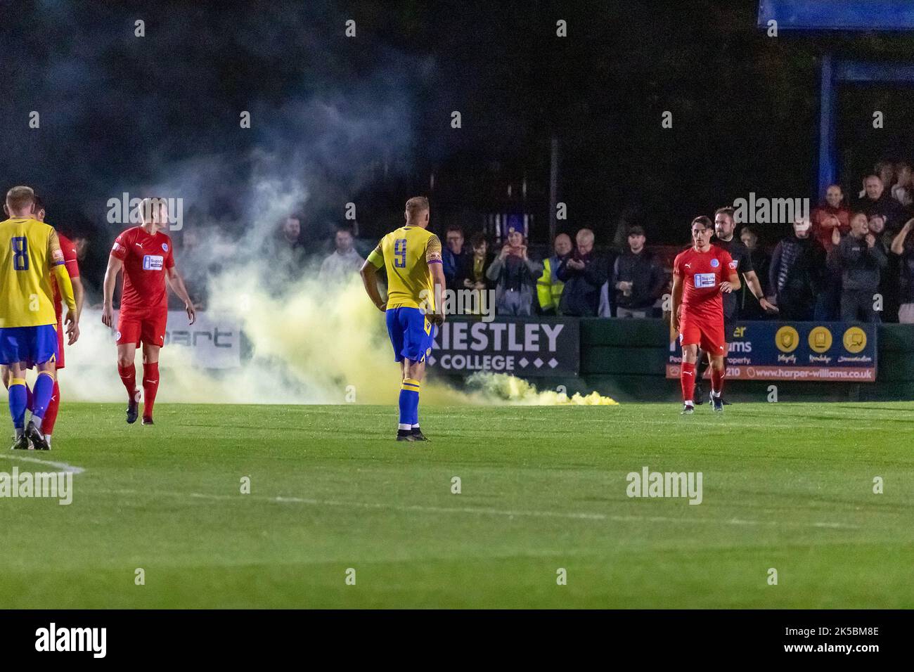 I razzi vengono lanciati in campo in una partita di calcio 'Derby' a Warrington, Chehsire Foto Stock